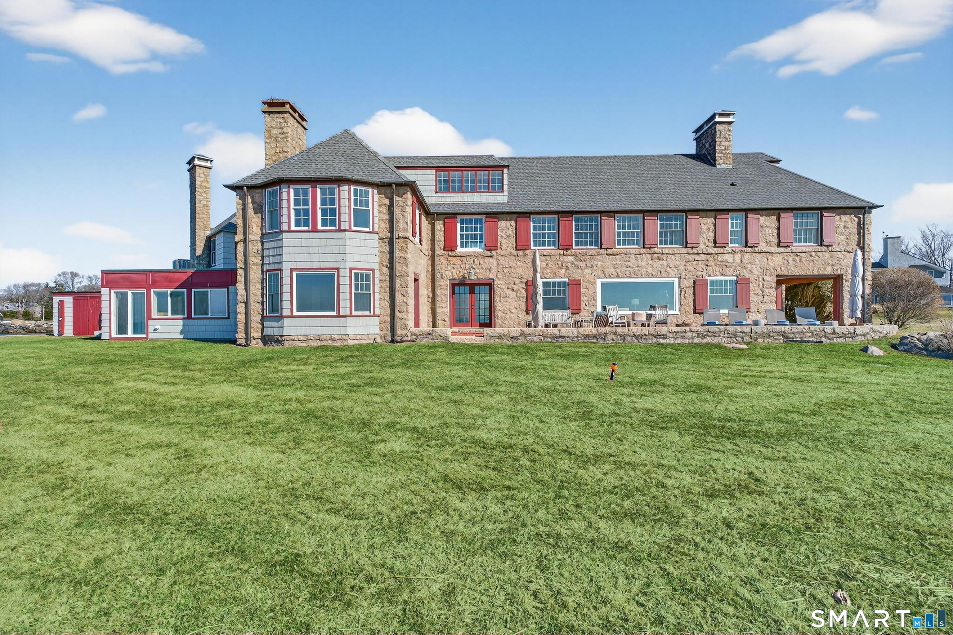39 Vineyard Place Guilford, CT 06437 - Photo 36 of 41 a front view of building with yard and outdoor seating