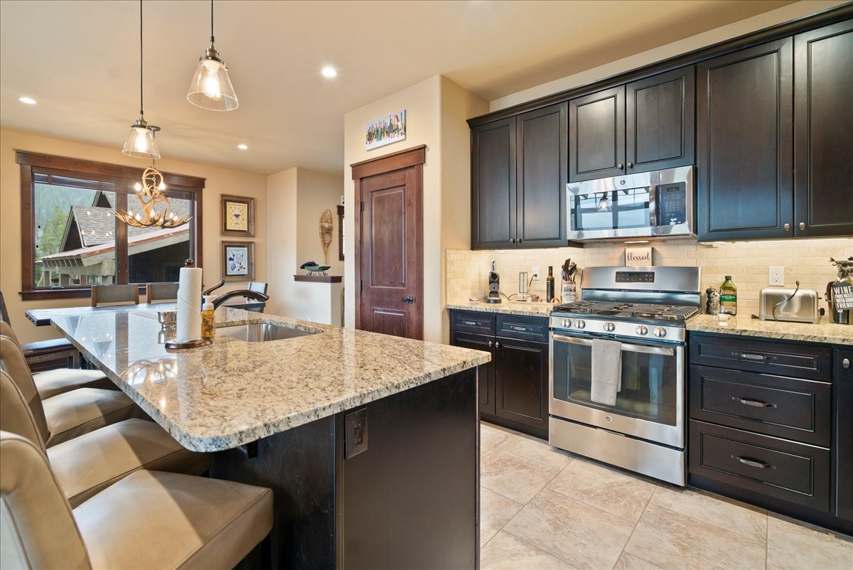 853 Independence Road, Unit 853 Keystone, CO 80435 - Photo 11 of 37 a kitchen with stainless steel appliances granite countertop a sink stove and refrigerator
