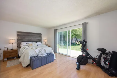 a bedroom with a bed and a large window