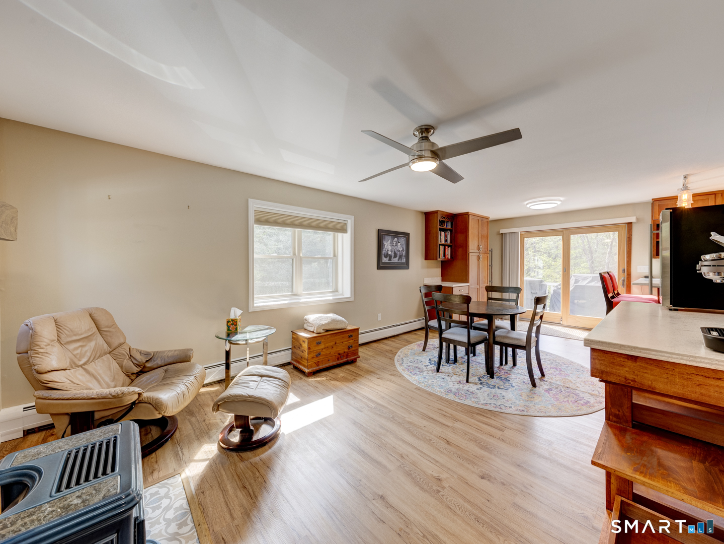 97 Lair Road New Hartford, CT 06057 - Photo 11 of 39 a living room with furniture and a flat screen tv with kitchen view
