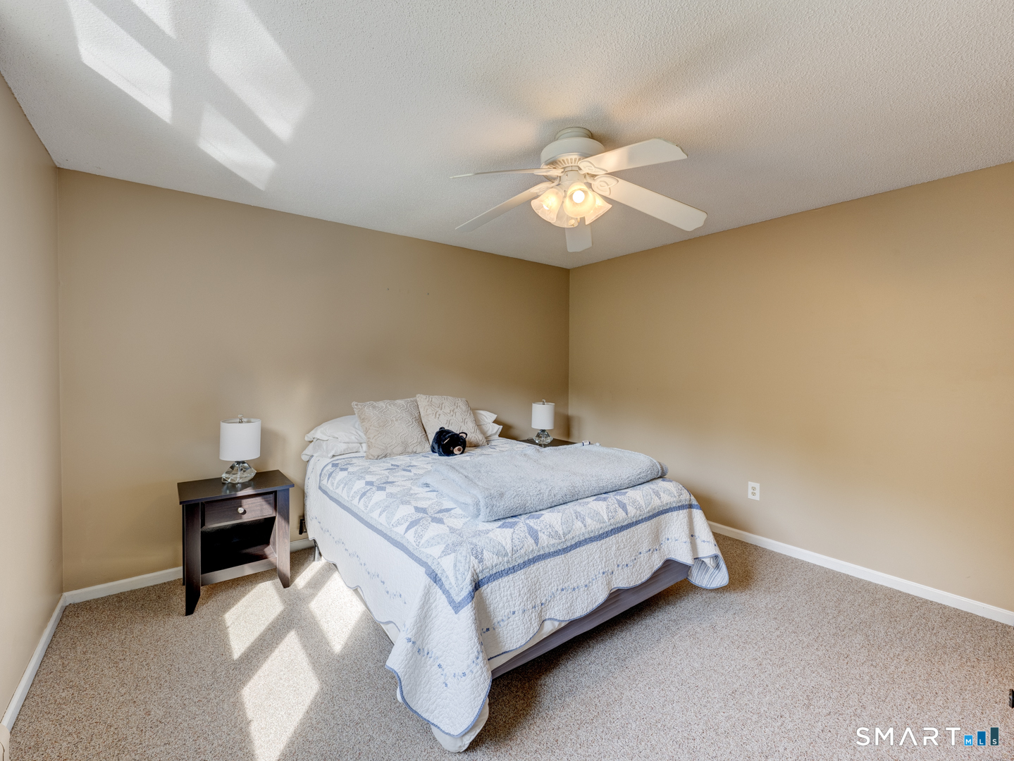 97 Lair Road New Hartford, CT 06057 - Photo 30 of 39 a bedroom with a bed and a chandelier