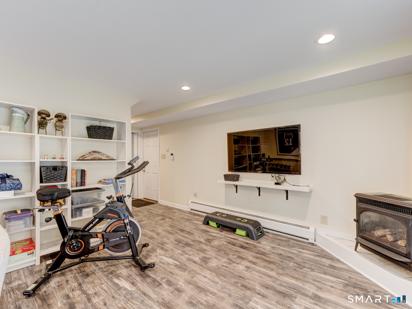 97 Lair Road New Hartford, CT 06057 - Photo 33 of 39 a view of a livingroom with workspace and a flat screen tv