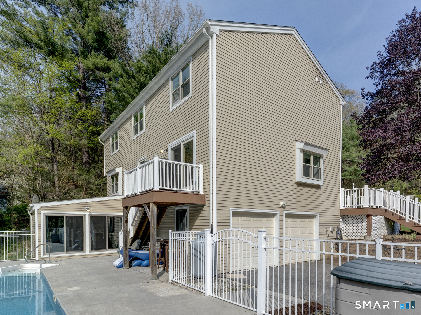 97 Lair Road New Hartford, CT 06057 - Photo 5 of 39 a view of a white house with large windows and a small yard