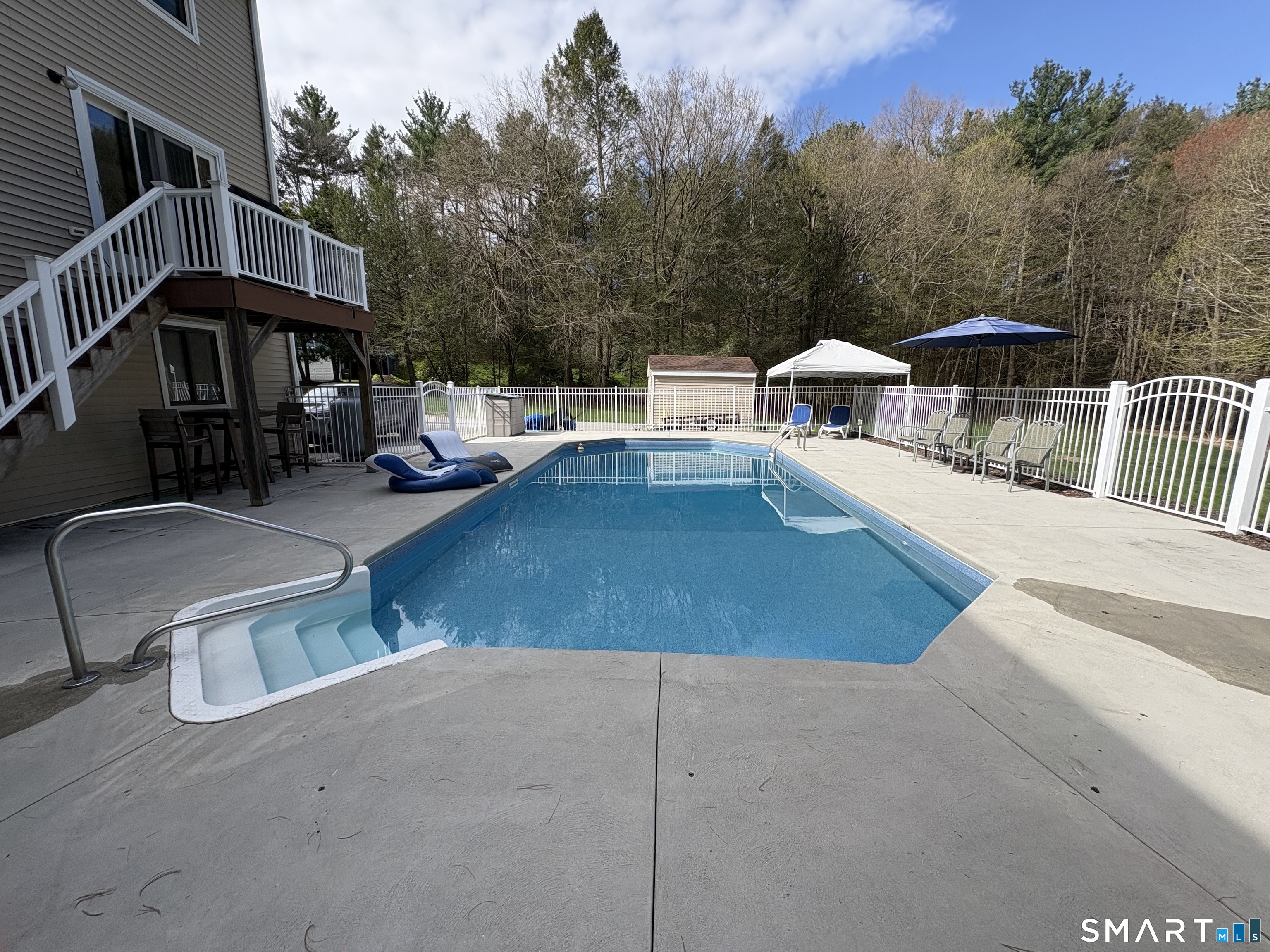 97 Lair Road New Hartford, CT 06057 - Photo 6 of 39 a view of a swimming pool with a patio