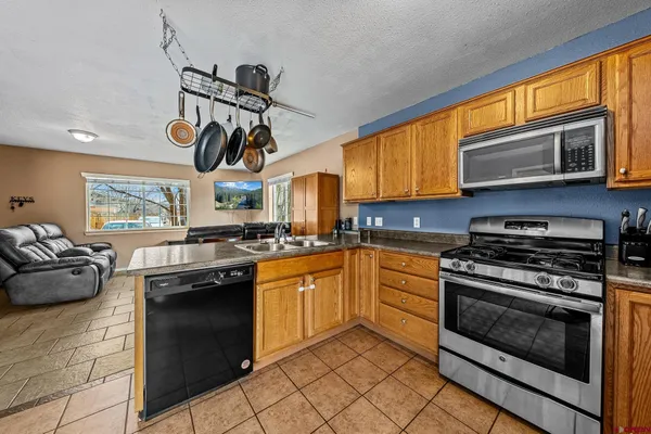 a kitchen with stainless steel appliances granite countertop a stove and a sink
