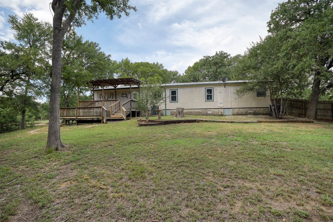 243 Piney Ridge Drive Bastrop, TX 78602 - Photo 23 of 40 a view of a backyard with a garden and trees