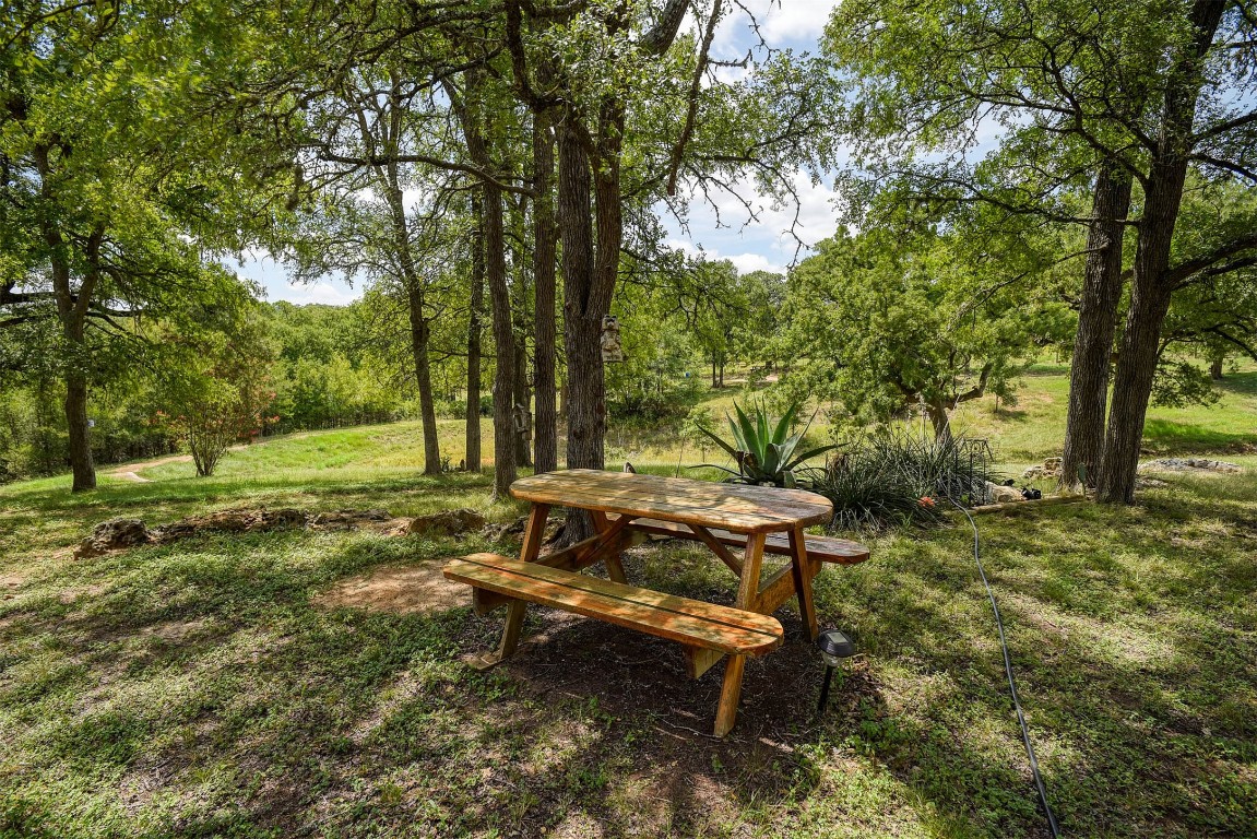 243 Piney Ridge Drive Bastrop, TX 78602 - Photo 6 of 40 a view of a bench in a garden