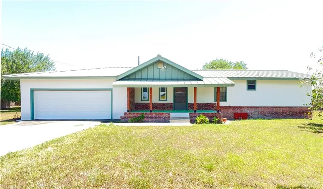 a front view of house with yard outdoor seating and barbeque oven