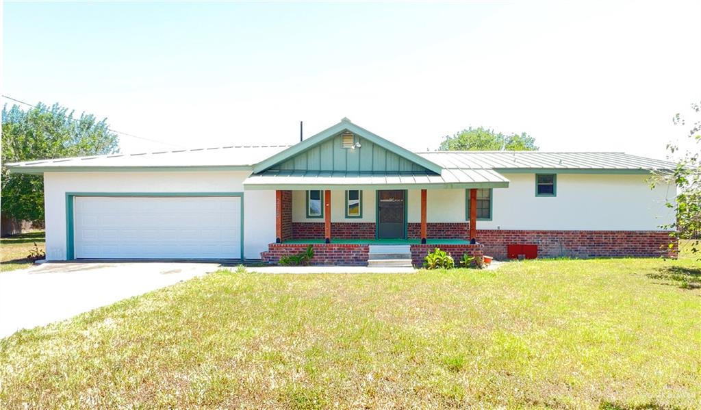 218 East Colorado Street Rio Hondo, TX 78583 - Photo 1 of 18 a front view of house with yard outdoor seating and barbeque oven