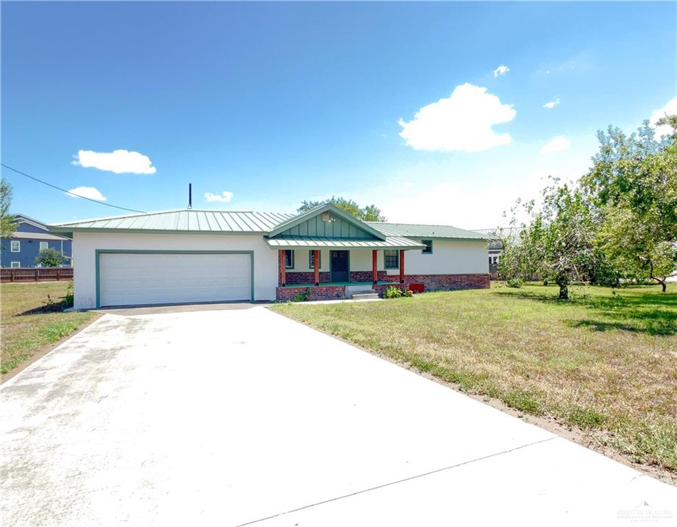 218 East Colorado Street Rio Hondo, TX 78583 - Photo 2 of 18 a front view of a house with a yard and garage