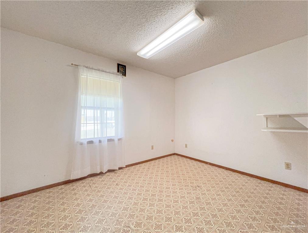 218 East Colorado Street Rio Hondo, TX 78583 - Photo 6 of 18 an empty room with windows