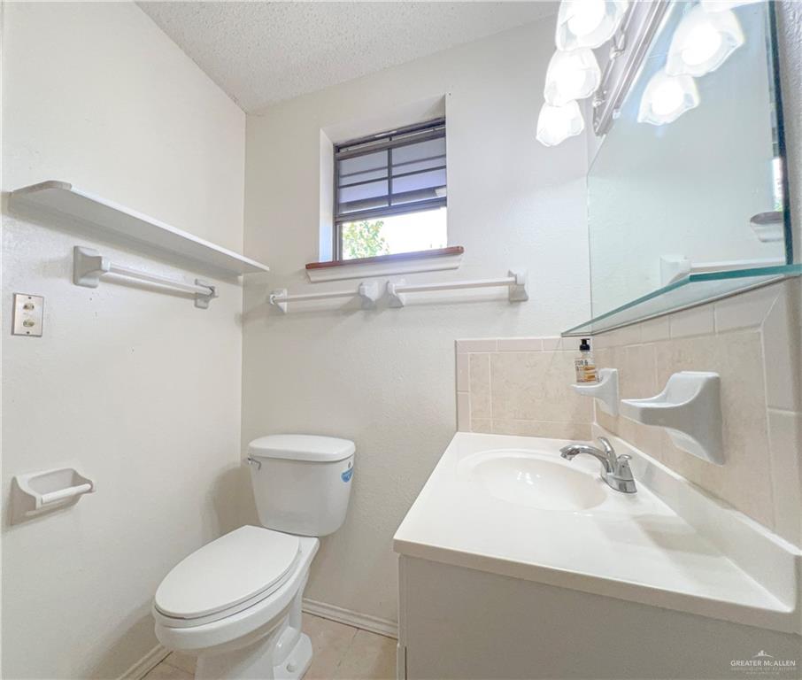 218 East Colorado Street Rio Hondo, TX 78583 - Photo 8 of 18 a bathroom with a sink a mirror and a toilet