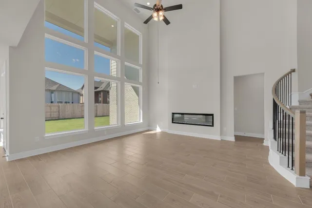 a open kitchen with a sink and dishwasher with wooden floor