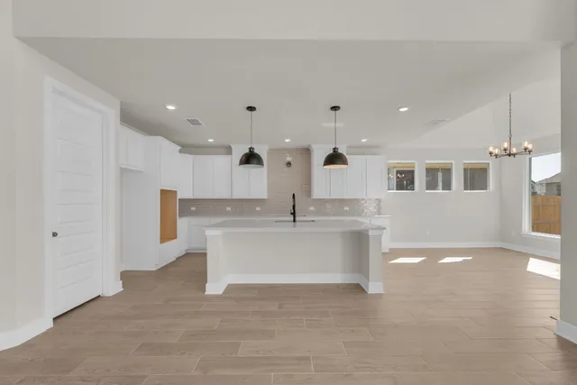 a view of kitchen with cabinets and wooden floor