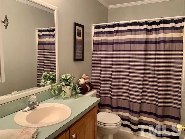 4154 Culbreth Road Stem, NC 27581 - Photo 12 of 19 a bathroom with a sink toilet and shower