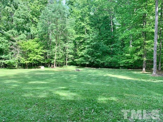 4154 Culbreth Road Stem, NC 27581 - Photo 17 of 19 a view of a grassy field with trees