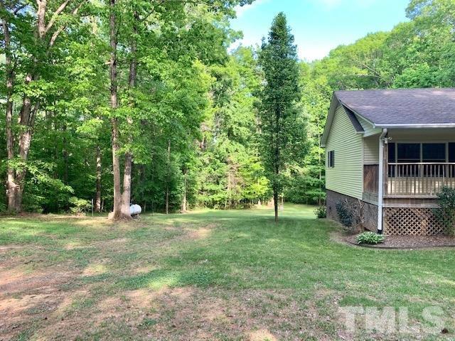 4154 Culbreth Road Stem, NC 27581 - Photo 19 of 19 a view of a backyard with a garden