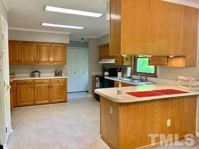 4154 Culbreth Road Stem, NC 27581 - Photo 5 of 19 a kitchen that has a sink and a stove in it