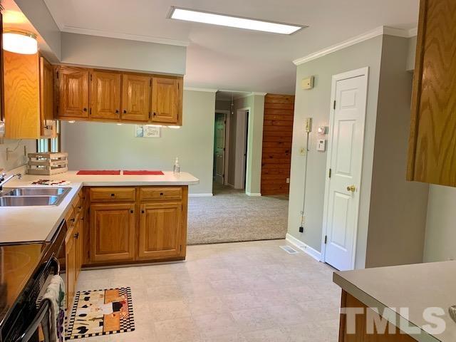 4154 Culbreth Road Stem, NC 27581 - Photo 6 of 19 a kitchen with stainless steel appliances granite countertop a sink stove and cabinets