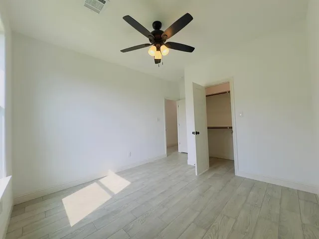 a view of an empty room and wooden floor