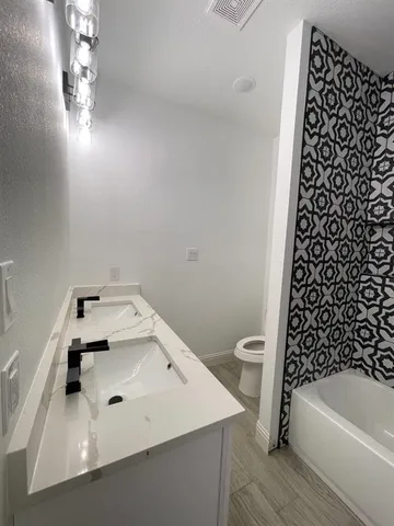 a bathroom with a bathtub and shower