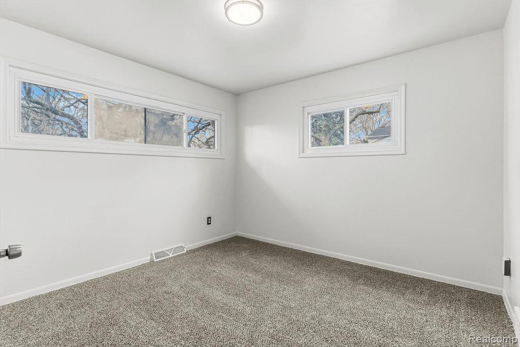 3485 Hammerberg Road Flint, MI 48507 - Photo 19 of 35 Spare room featuring carpet and healthy amount of natural light
