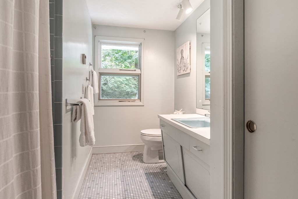 14 Driftwood Road Marblehead, MA 01945 - Photo 16 of 30 a bathroom with a sink a toilet and a window