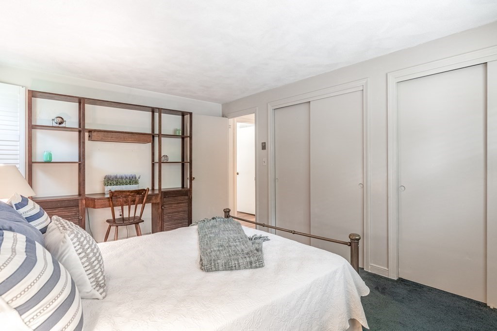 14 Driftwood Road Marblehead, MA 01945 - Photo 18 of 30 a bedroom with a bed a table and large window with view of balcony