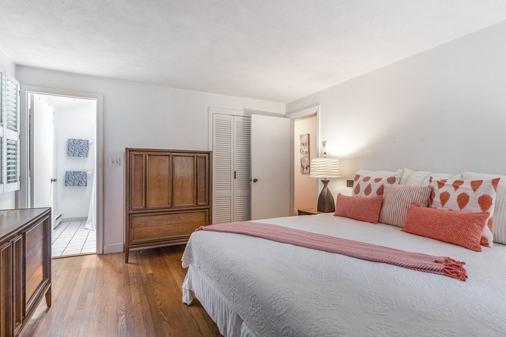 14 Driftwood Road Marblehead, MA 01945 - Photo 20 of 30 a bedroom with a large bed and wooden floor