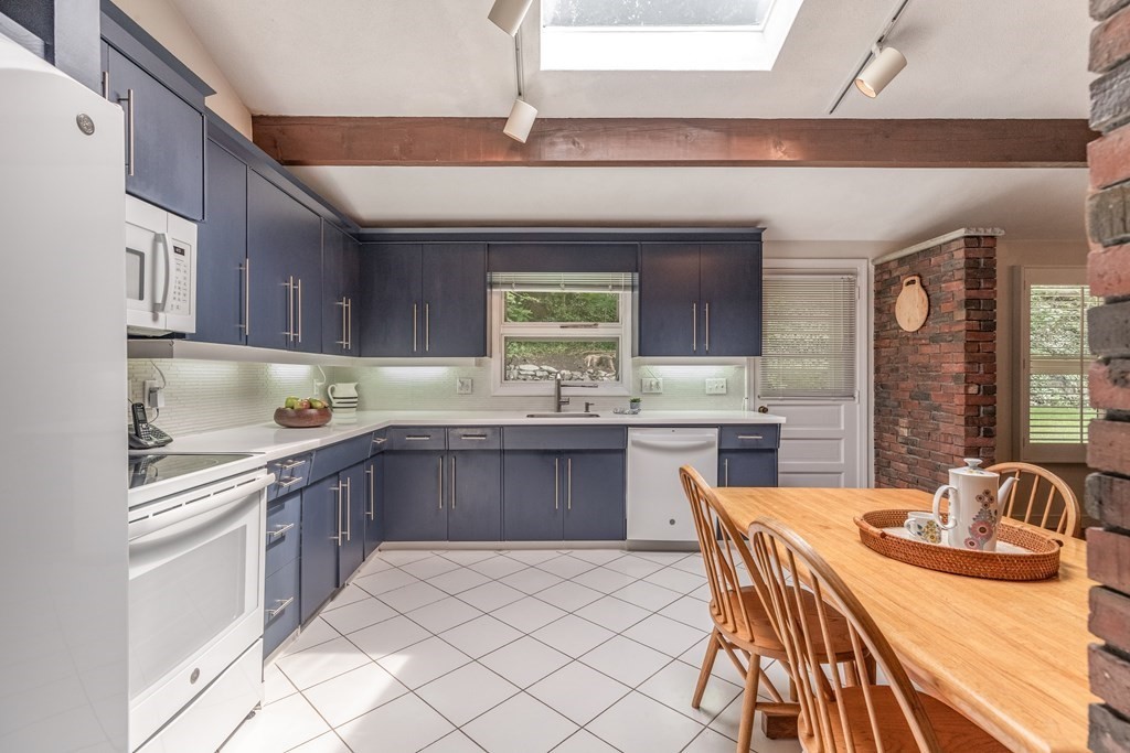 14 Driftwood Road Marblehead, MA 01945 - Photo 7 of 30 a kitchen with stainless steel appliances granite countertop a sink a stove a dining table and chairs