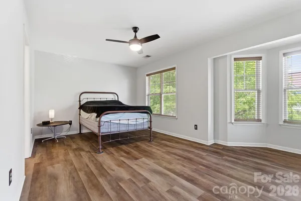 a living room with a bed furniture and a window