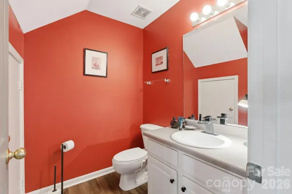 a bathroom with a sink a toilet and mirror