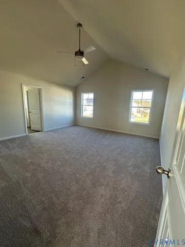 en empty room with windows and ceiling fan view