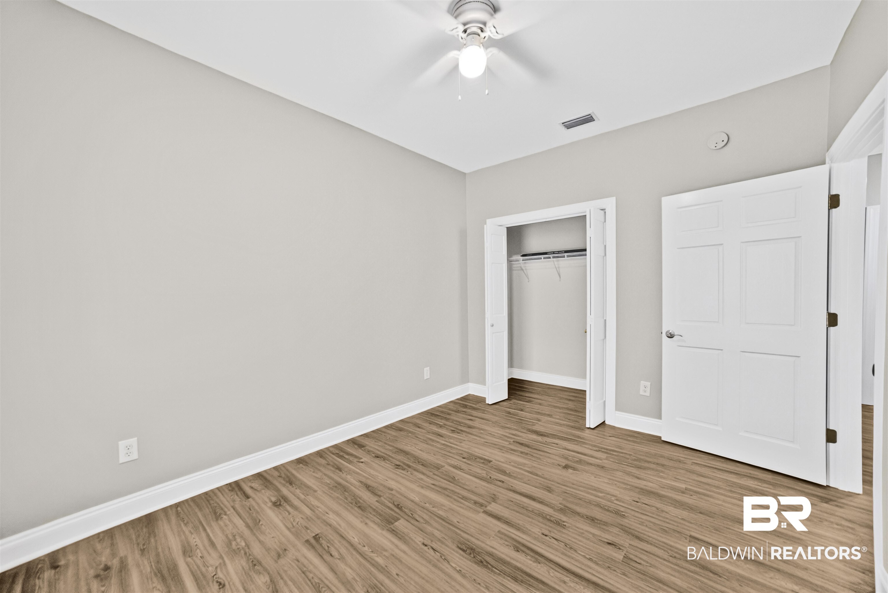 5913 Antoine Road Mobile, AL 36693 - Photo 18 of 33 Interior room featuring wood-finish flooring, light gray walls, and white baseboards