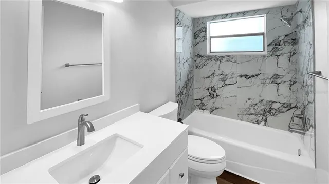 a bathroom with a sink a toilet and a bathtub