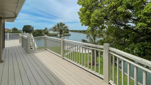 a view of a balcony with wooden floor and fence