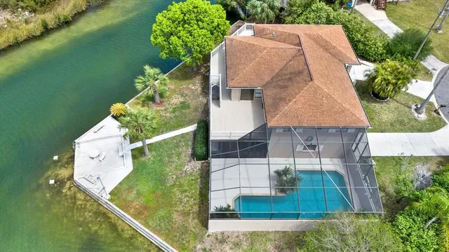 an aerial view of a house with pool garden and patio