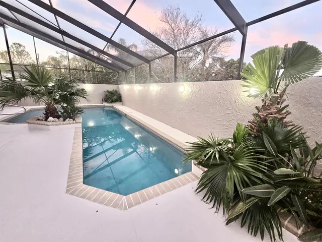 a view of a swimming pool with a yard