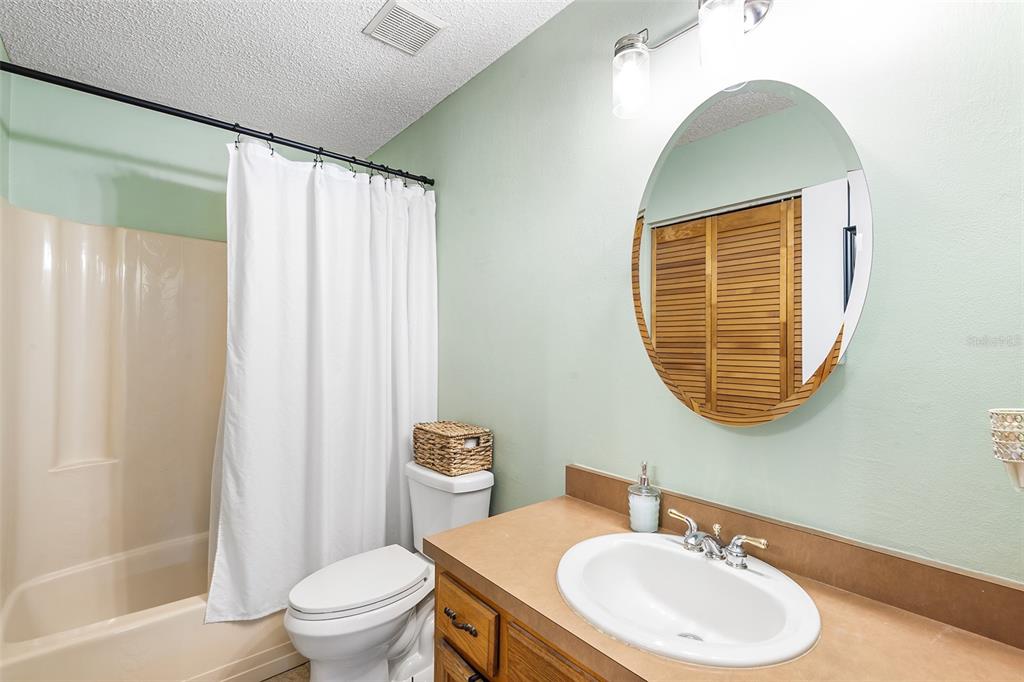 1233 St Anne Shrine Road Lake Wales, FL 33898 - Photo 12 of 47 a bathroom with a toilet a sink and a mirror