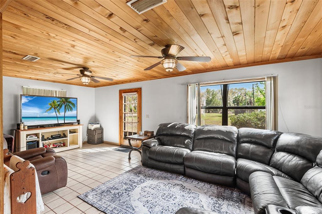 1233 St Anne Shrine Road Lake Wales, FL 33898 - Photo 15 of 47 a living room with furniture a flat screen tv next to a window