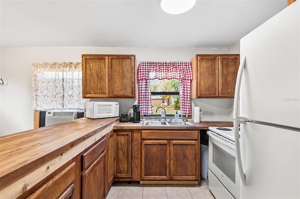 1233 St Anne Shrine Road Lake Wales, FL 33898 - Photo 21 of 47 a kitchen with a sink stove and refrigerator