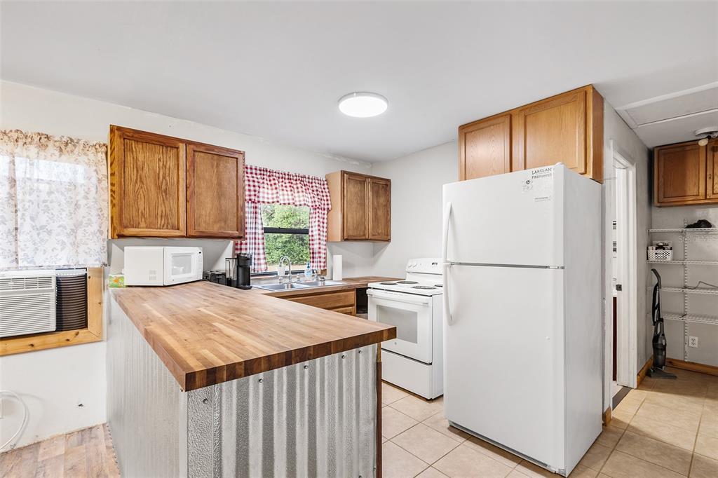 1233 St Anne Shrine Road Lake Wales, FL 33898 - Photo 22 of 47 a kitchen with a refrigerator a stove and a refrigerator