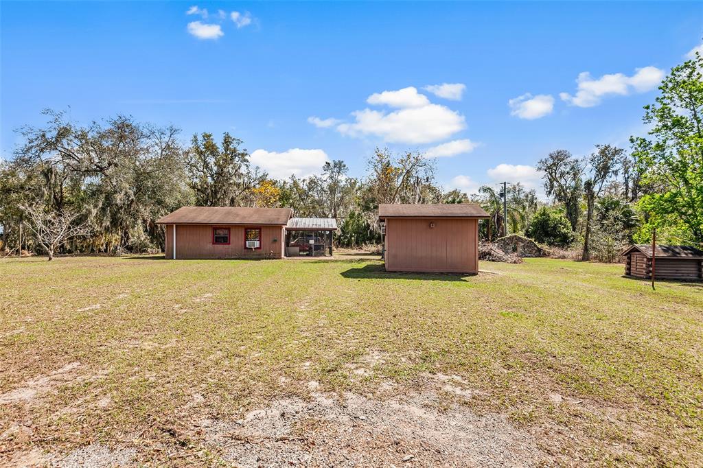 1233 St Anne Shrine Road Lake Wales, FL 33898 - Photo 42 of 47 a front view of a house with a yard and a garage