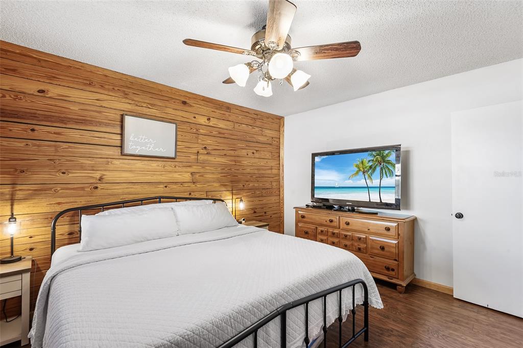 1233 St Anne Shrine Road Lake Wales, FL 33898 - Photo 10 of 47 a bedroom with a bed and a chandelier