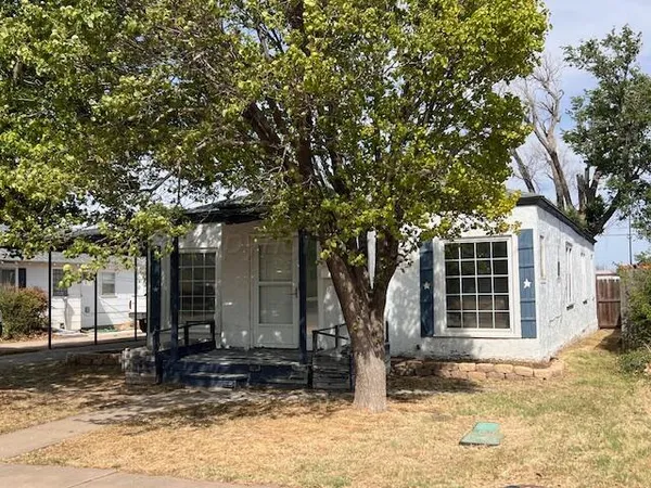 a tree in front of a house
