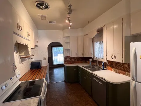 a kitchen with a sink stove and cabinets