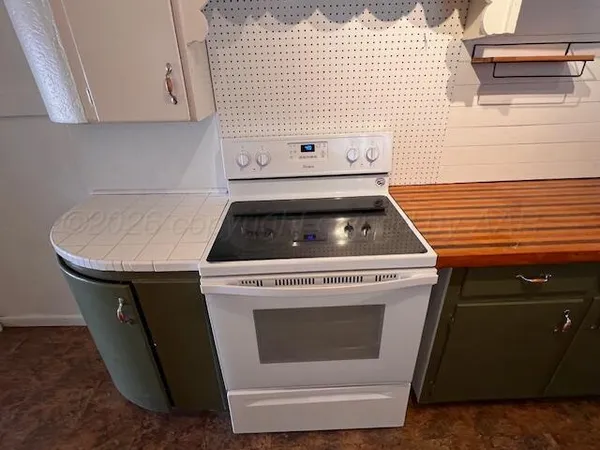 a stove top oven sitting inside of a kitchen