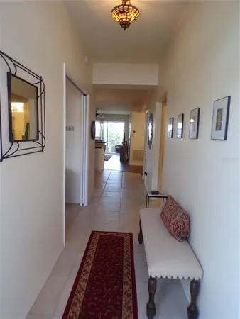 a kitchen with a sink a stove a refrigerator cabinets and dining table