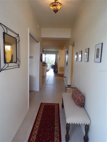 a kitchen with a sink a stove a refrigerator cabinets and dining table