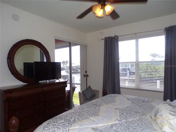 a bedroom with a bed and cabinet